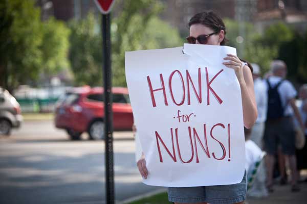 Anna O'Connor holds a sign 
