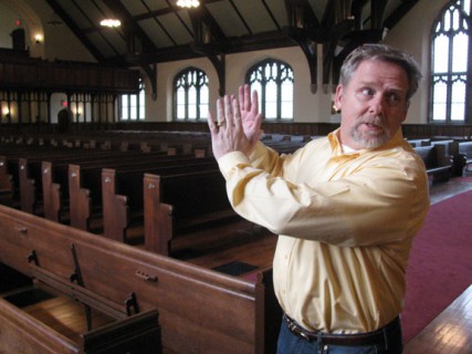 Jerry Patengale, who was hired by the Green family to help find a new owner of a college campus in Northfield, Mass., points out the stone chapel that was once deemed unsafe but has been repaired. 