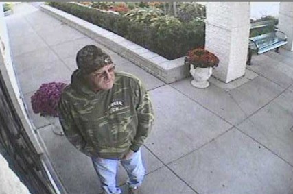 Perrysburg Township police released this photo of a ?person of interest? taken by a security camera outside the entrance to the Islamic Center of Greater Toledo. The Council on American-Islamic Relations has announced a $5,000 reward for information leading to the arrest and conviction of the arson perpetrator.   