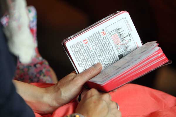 A woman uses a missal during a traditional Latin Mass at St. Michael the Archangel Chapel in Farmingville, N.Y., on June 17, 2012. The chapel is administered by the Society of St. Pius X. RNS photo by Gregory A. Shemitz