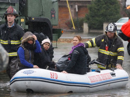 State Police, National Guard and Seacaucus Firefighters help families as they are rescued from their homes on Edstan Drive in Moonachie , NJ on 10/30/12. 