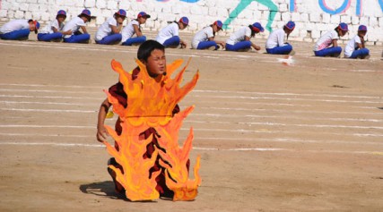 A Tibetan boy enacts self-immolation in Dharamsala, India, as part of a public event. 