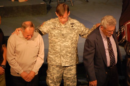 Scott McChrystal, a retired Army chaplain and the military/VA representative for the Assemblies of God, prays during a church service with other veterans. 