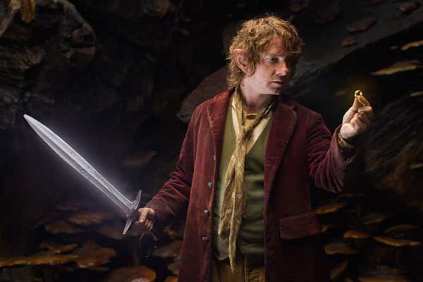 Martin Freeman as the Hobbit Bilbo Baggins with his sword, Sting, finds a small ring in Gollum’s cave in the fantasy adventure “THE HOBBIT: AN UNEXPECTED JOURNEY,” a production of New Line Cinema and Metro-Goldwyn-Mayer Pictures (MGM), released by Warner Bros. Pictures and MGM. 