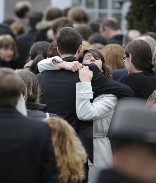 Mourners embrace outside Green Funeral Home in Fairfield, CT during the funeral for Noah Pozner, a victim of the Newtown shootings. RNS photo by Robert Deutsch, USA TODAY