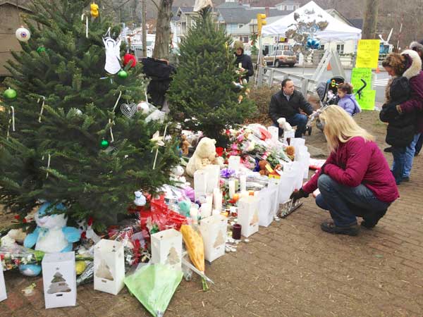 Memorial of candles, flowers, stuffed animals, and cards for the children and 6 adults who died at the Sandy Hook Elementary School