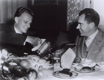 Billy Graham pours coffee for Vice-president Richard M. Nixon at a Washington luncheon.