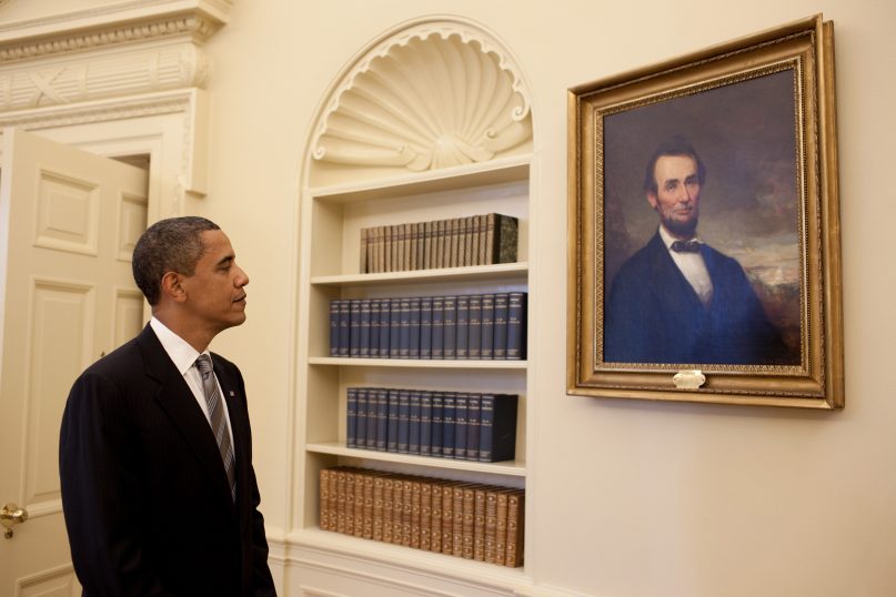 (RNS1-jan16) President Barack Obama looks at the portrait of Abraham Lincoln  in the Oval Office. RNS photo by Pete Souza/The White House.