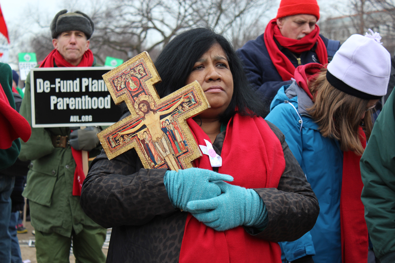 Dunia Minnium of Voorhees, N.J., holds a cross during the 2013 March for Life in Washington, D.C. on Jan. 25.  RNS photo by Adelle M. Banks.