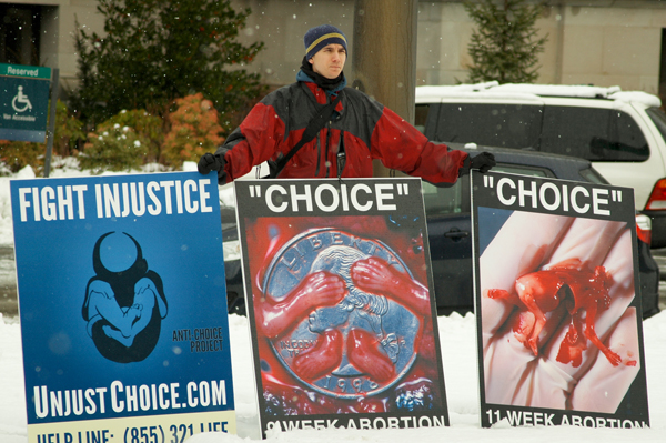 An Anti-Choice Project member holds anti-abortion signs during the 2012 March for Life in Olympia, Wash. RNS photo courtesy the Anti-Choice Project. *Note: This photo may only be used with RNS-ROE-GRAPHIC.