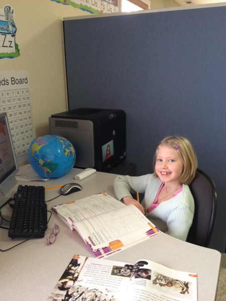 Sadie Bell studies at a desk.  Regarding virtual school, Sadie's mom Jennifer Bell says, “We liked the lifestyle that it brought to our family. We had so much more time to spend with them, and to instill our values in them.”  RNS photo courtesy Jennifer Bell.