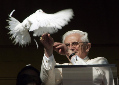 Pope Benedict XVI looks at a white dove after it was released from the window of his private apartment at the end of the Sunday Angelus prayer at the Vatican January 28, 2007. The Pope delivered a message of peace on Sunday, flanked by two children who released two doves. REUTERS/Alessandro Bianchi (VATICAN) 
