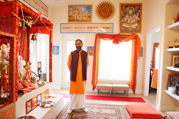 Priest, Mahesh Shatri, in his condo, which is decorated like a temple. ShantiNiketan, located in Tavares, Fl., is a gated retirement community catering to Indian immigrants. Residents dine on vegetarian meals, partake in daily yoga as well as Bhajans (prayer) everyday at noon. Some women dress in traditional sarees and their is a strong sense of community. RNS photo by Julie Fletcher.