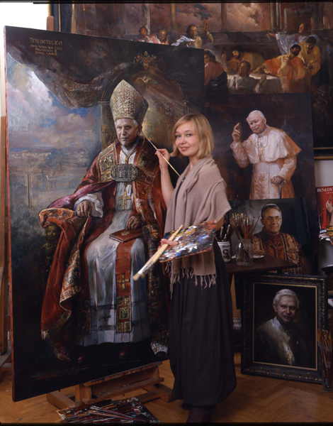 As the popes' official painter, Natalia Tsarkova says she tries to capture both the physical reality and the spiritual essence of her subjects.  Tsarkova poses in front of the official portrait of Pope Benedict XVI she painted in 2007.  RNS photo courtesy Natalia Tsarkova.