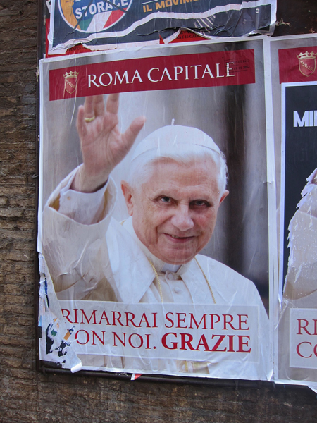 A poster of Pope Benedict XVI on the streets of Rome. The conclave to pick a new pope will begin on Tuesday (March 12) the Vatican said Friday, resolving an open question that had dogged the cardinals meeting here over the past week. RNS photo by David Gibson