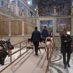 In preparation for the conclave and announcement of a new pope, workers carry chairs into the Sistine Chapel at the Vatican. The conclave to pick a new pope will begin on Tuesday (March 12) the Vatican said Friday, resolving an open question that had dogged the cardinals meeting here over the past week. RNS photo by David Gibson 