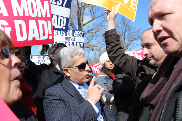 Left to right, Pastor Abel Palomo of College Park, Md., and Collete DiMemmo of Altoona, Pa., debate with Washington, D.C., resident John Rohrer and his husband, John Lestitian, across the street from the Supreme Court. Throngs of supporters and opponents gathered outside the high court as it considered cases about same-sex marriage. RNS photo by Adelle M. Banks