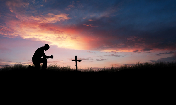 Man praying over a grave image courtesy Shutterstock (http://shutr.bz/YV9NHY)