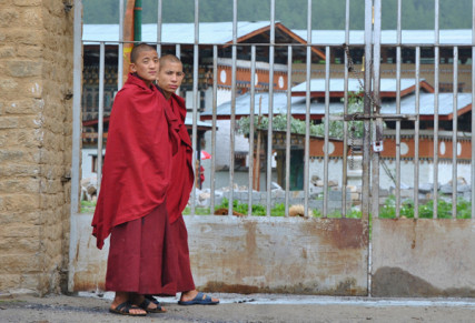 Two young monks at the gate of a monastery in Thimphu. Photo by Vishal Arora
