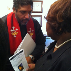 The Rev. William J. Barber II consulting with church member Shyrl Hinnant Uzzell. RNS photo by Yonat Shimron