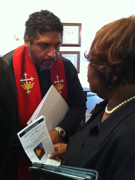 The Rev. William J. Barber II consulting with church member Shyrl Hinnant Uzzell. RNS photo by Yonat Shimron