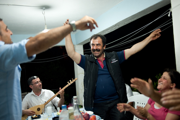 Vahe Capar dances at an impromptu party at his home while Semsettin Donmez plays a variety of Turkish, Armenian and Arabic folk songs on his baglama. The partygoers were a diverse mix of Turks, Armenians and Arabs, as well as Muslims and Christians. The music and raki, an anise-flavored liquor, brought them together. Photo by Sait Serkan Gurbuz/VAKIFLI.COM