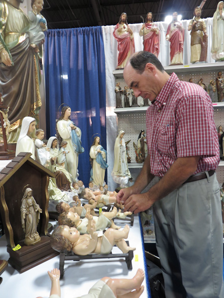 Giovanni Pierinelli of Santa Teresita checks on his Baby Jesus inventory at the 17th annual trade show of the Catholic Marketing Network last week (Aug. 6-9) in Somerset, N.J. RNS photo by David Gibson.