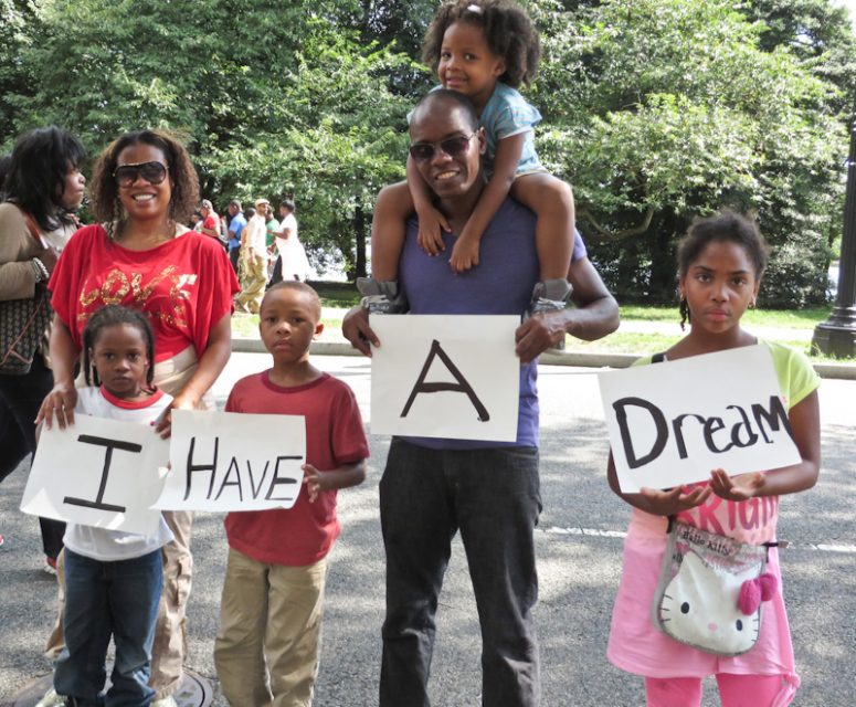 The James family of Miami, Fla., including (left to right), mother Tanya; Gabriel, 6; Levi, 8; father Kwaku; Zoe, 3; and Shyanne, 10, pose for a photo with their “I Have A Dream” signs as they depart the National Action to Realize the Dream march that marked the 50th anniversary of the March on Washington. RNS photo by Adelle M. Banks