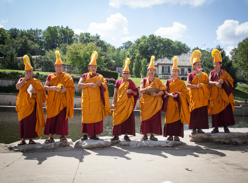 Visiting monks from Drepung Gomang Monastery in India finalize the sand mandala closing ceremony by throwing the sand into the waters at Brush Creek in Kansas City, Mo. on Saturday, Aug. 17, 2013.