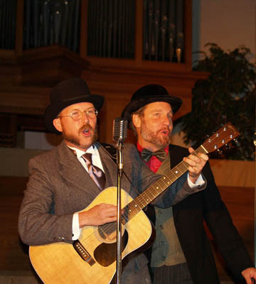 Tony Jones, left, and Mark Scandrette portray traveling evangelists circa 1908 in the Church Basement Roadshow, a light-hearted tour performed by leaders of Emergent Village. Religion News Service photo courtesy Doug Pagitt