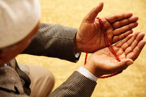 Hands with muslim prayer beads