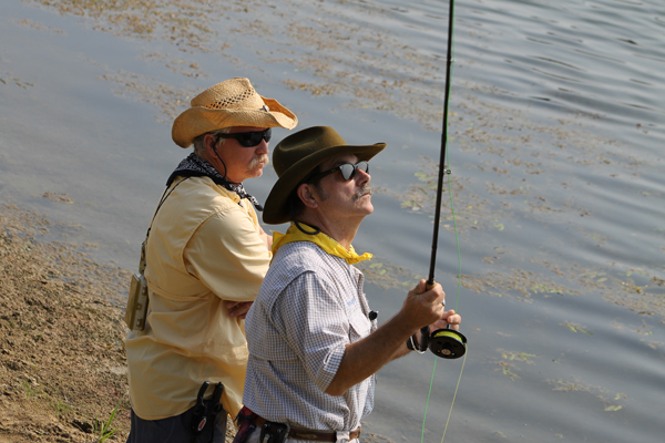 Mark Marmon (right) teaches fly fishing at the Fishers of Men retreat at Camp Allen in Navasota, Texas. Photo by Emily Krueger, Camp Allen | courtesy The Episcopal Diocese of Texas