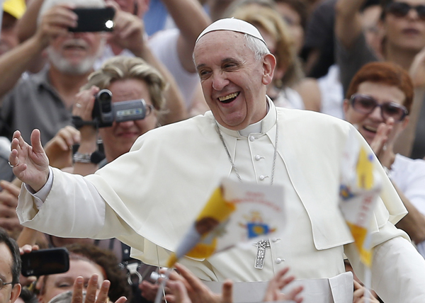 Pope Francis greets the crowd as he arrives to lead his general audience in St. Peter's Square at the Vatican on Wednesday, Sept. 11. Photo by Paul Haring/Catholic News Service