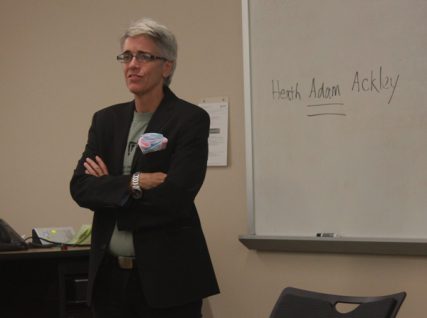 During one of Dr. H. Adam Ackley's classes, he tells his students for the first time of his transgender identity. He had just written his preferred name on the board. Photo by Annie Z. Yu
