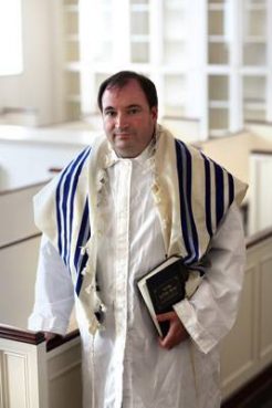 Rabbi Charles E. Savenor, director of congregational enrichment for the United Synagogue of Conservative Judaism, wears a prayer shawl (striped) over his kittel, a white shroud worn by some Jews during the High Holy Days of Rosh Hashana and Yom Kippur. Religion News Service photo by Michael Falco