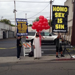 Man dressed as Jesus protests anti-gay protesters at the 2013 Los Angeles AIDS Walk. Photo courtesy of Brody Brown via Instagram.