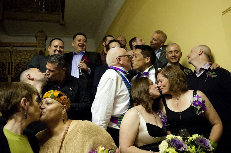 Couples kiss after they participated in the first same-sex marriage ceremony in Jersey City, N.J., officiated by Mayor Steve Fulop at 12:01 a.m. Monday, Oct. 21, 2013, at City Hall. Photo by Reena Rose Sibayan/The Jersey Journal - courtesy The Star-Ledger