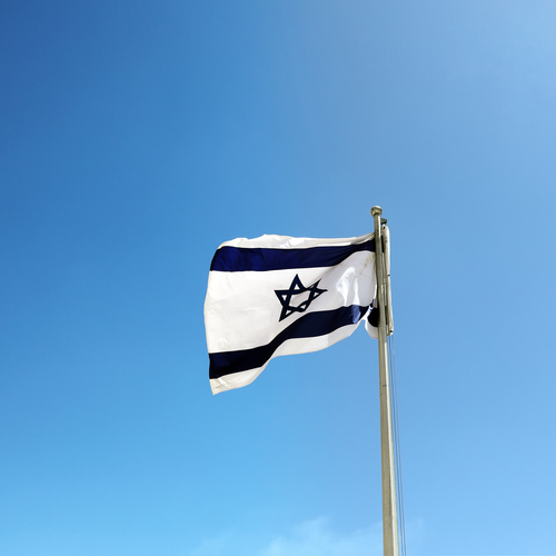 Israel flag against a blue sky