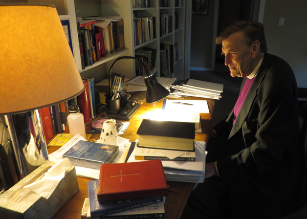 John Shelby Spong sits at his desk at his New Jersey home on Sept. 12, 2013. The liberal churchman writes longhand with a fountain pen on yellow legal pads. RNS photo by David Gibson