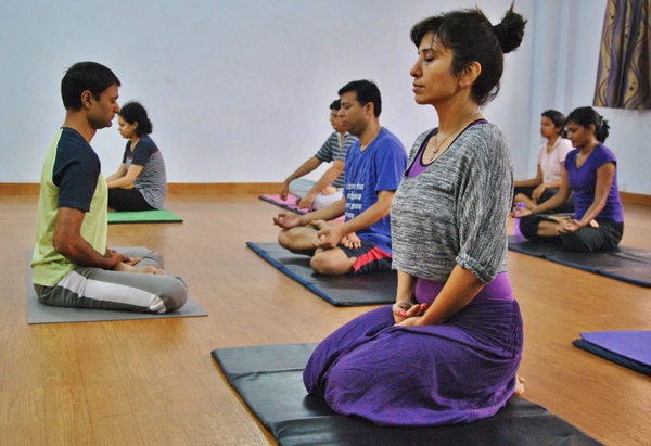 Private yoga instructor Shailendra Singh (far right) leads a group of young professionals at The Yoga Guru club in Noida in Delhi's suburbs on Oct. 25, 2013. Photo by Vishal Arora