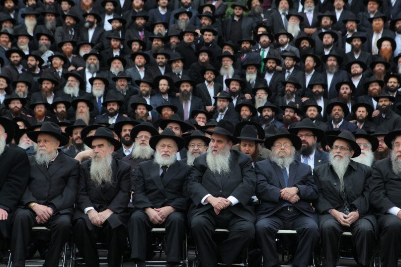 From left, Rabbi Binyomin Klein, Rabbi Avraham Shemtov, Rabbi Yehuda Krinsky, Rabbi Moshe Kotlarsky, Rabbi Moshe Feller, and Rabbi Zalman A. Grossbaum are seen among a sea of black hats as they pose for a group photo in front of Chabad-Lubavitch world headquarters in the Brooklyn borough of New York on Sunday (Nov. 3). They are among nearly 4,000 rabbis from around the world who are in New York for the International Conference of Chabad-Lubavitch Emissaries, an annual event aimed at reviving Jewish awareness and practice around the world. Photo courtesy Meir Alfasi / Chabad.org