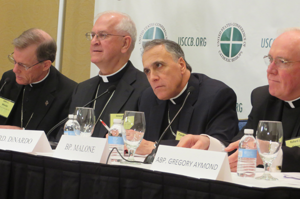 Newly elected president of the U.S. Conference of Catholic Bishops, center left, Archbishop Joseph E. Kurtz of Louisville, Ky. and new vice president, center right, Cardinal Daniel DiNardo of Galveston-Houston, speak to the press on Tuesday (Nov. 12) in Baltimore. RNS photo by David Gibson