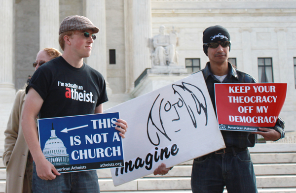 Demonstrators hold signs that read "Keep your theocracy off my democracy" and "This is not a church" in front of the Supreme Court on Wednesday (Nov. 6) during oral arguments of Greece v. Galloway. RNS photo by Katherine Burgess