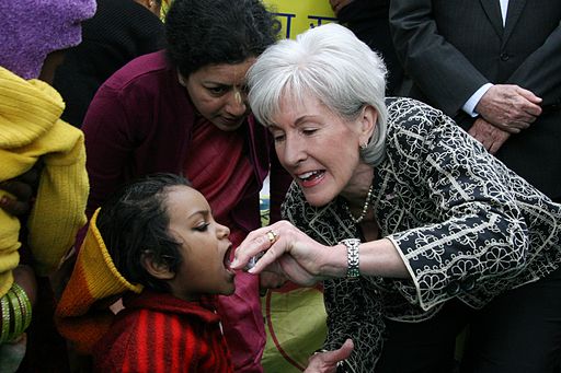 Kathleen Sebelius, Secretary of the U.S. Department of Health and Human Services, administers a polio vaccine to a child in New Delhi, India. HHS and USAID are among the partners supporting the Government of India’s campaign to eradicate polio. 