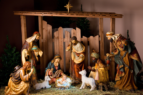 A Christmas manger scene with figurines including Jesus, Mary, Joseph, sheep and magi.