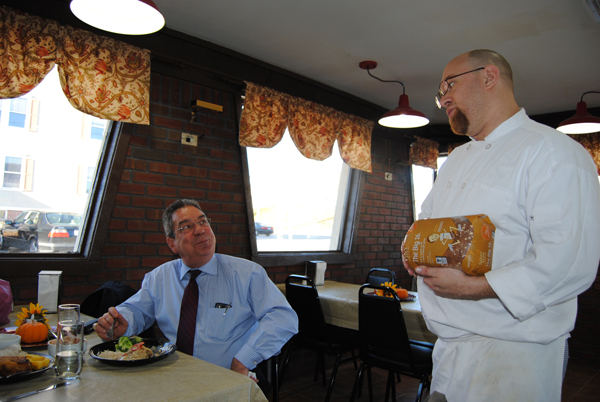 The Ark chef Matthew Blake, right, tells customer Michael Dubois about a bread made without oils. RNS photo by G. Jeffrey MacDonald