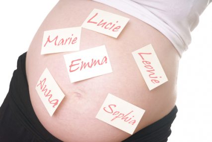 Pregnant woman with girl names on the belly.