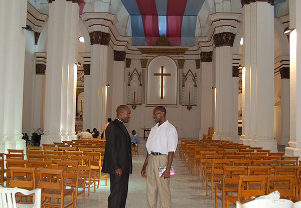 A Catholic priest converses with an Anglican pastor at the Christ the King Anglican Cathedral in Tripoli. The number of Anglicans is reportedly growing in Libya. RNS photo by Fredrick Nzwili