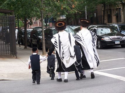 Ultra-orthodox Jews cross the street in Brooklyn.