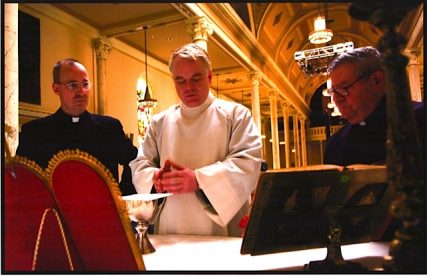 Philip Seymour Hoffman preparing for his role in "Doubt" by learning to say a Mass, circa 1963, on the set at the College of Mt. St. Vincent in Riverdale, NY. Father Jim Martin, SJ, who supplied the photo, is at left. 